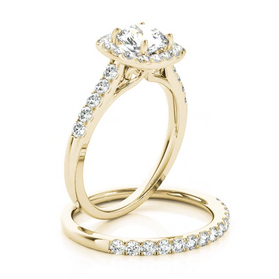 This delicate design engagement ring showcases a cushion halo pave set diamonds to frame a round cut diamond of your choice. Yellow Gold