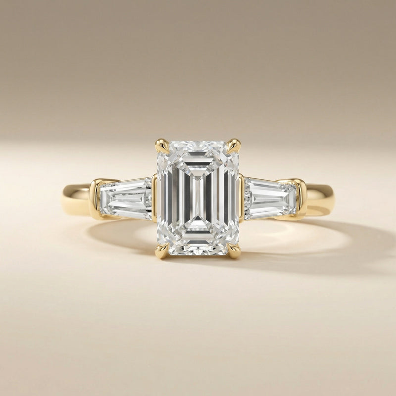 LUX-85336 Emerld Cut Three Stone Engagement Ring With Tapered Baguettes