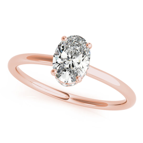 This elegant oval engagement ring features a sparkling hidden halo of diamonds that wraps around the center diamond.