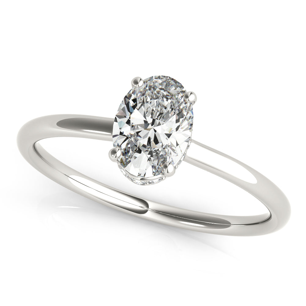 This elegant oval engagement ring features a sparkling hidden halo of diamonds that wraps around the center diamond.