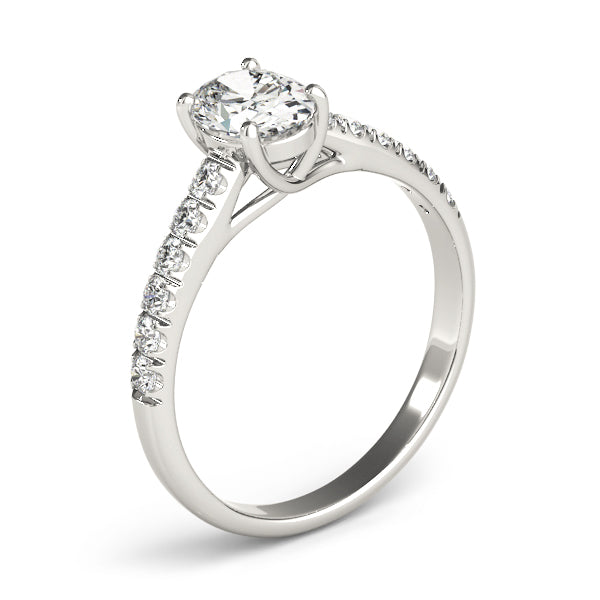 This beautiful oval diamond engagement ring showcases round diamonds that are set in pave design to accent your center diamond.