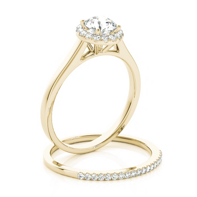 This classic halo engagement ring features a micro pave set diamonds around the center gem. Yellow Gold