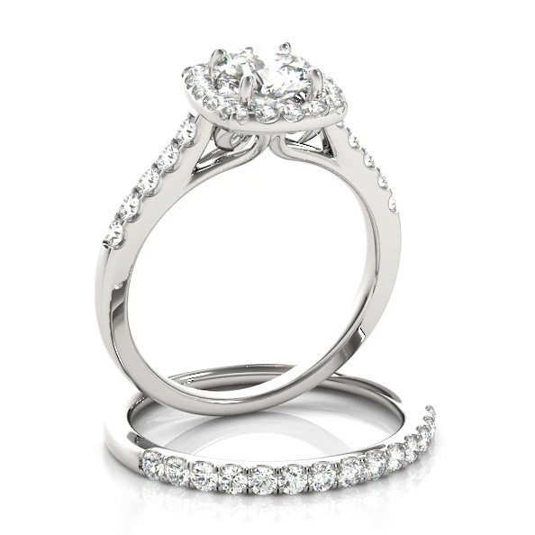 This delicate design engagement ring showcases a cushion halo pave set diamonds to frame a round cut diamond of your choice.