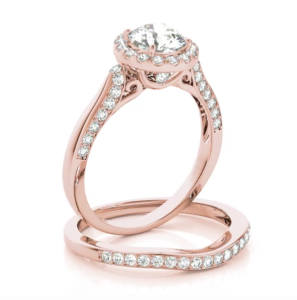 Beautiful in every way, this diamond engagement ring features round diamonds set in a halo design. Pink Gold