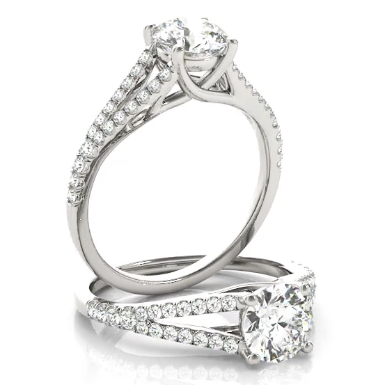 This delicate design engagement ring showcases a cushion halo pave set diamonds to frame a round cut diamond of your choice. White Gold